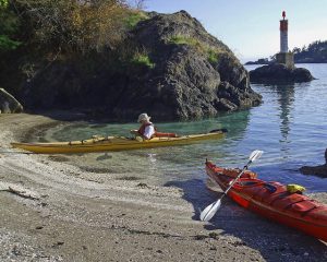 Two kayaks on a midden cove, Pender Island BC
